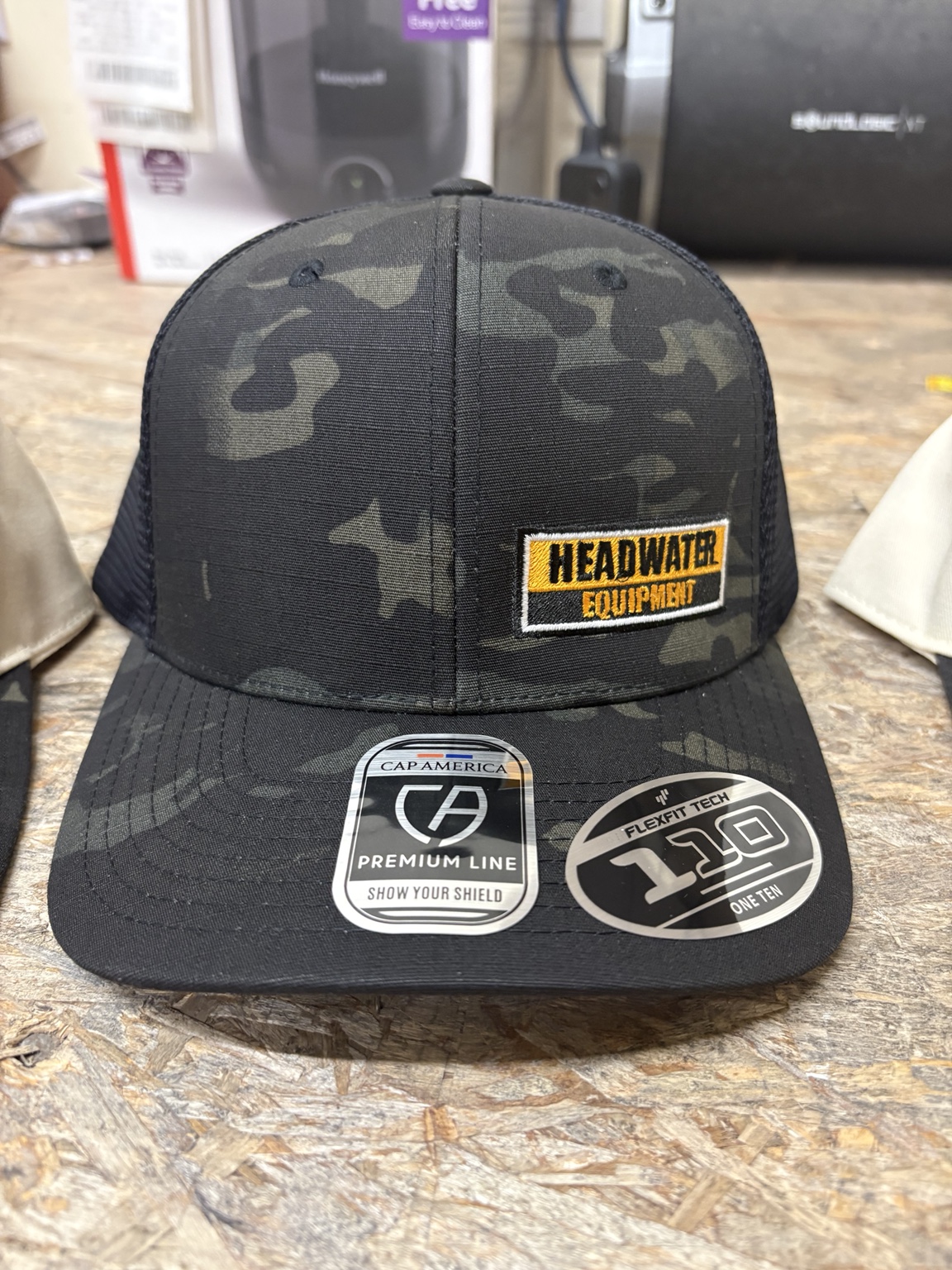 Headwater Equipment custom hat — Embroidered patch on camo